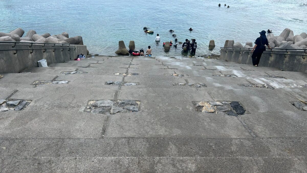ゴリラチョップのコンクリートのエントリー階段と階段下で海に入るダイバー